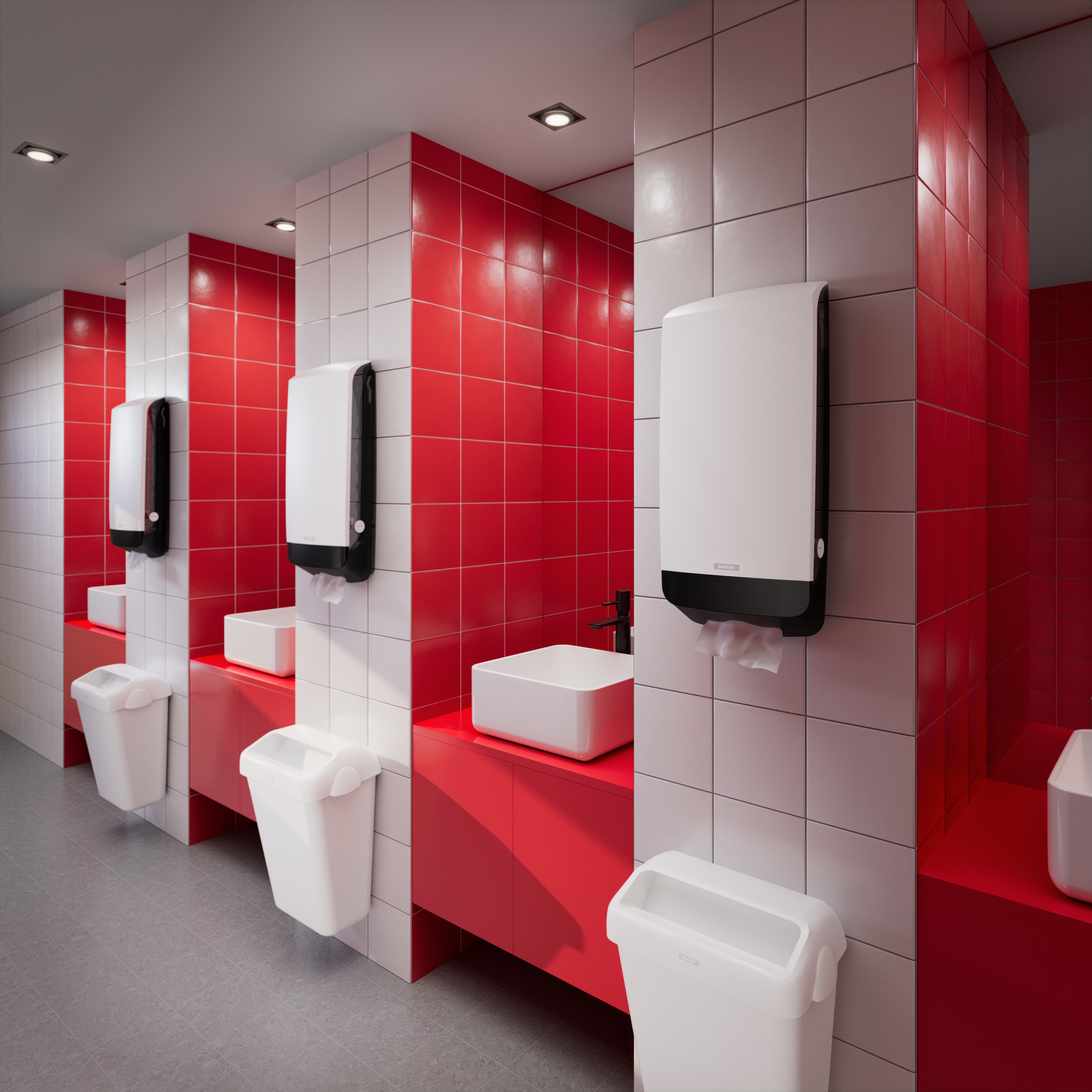 Toalettutrymme med röda och vita kakelväggar och väggmonterade Katrin XL Dispensers ovanför handfat.