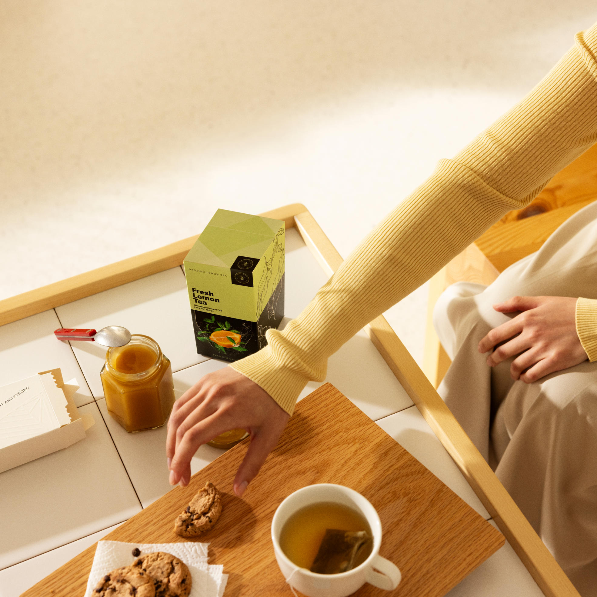 A hand reaches for food in a breakfast setting