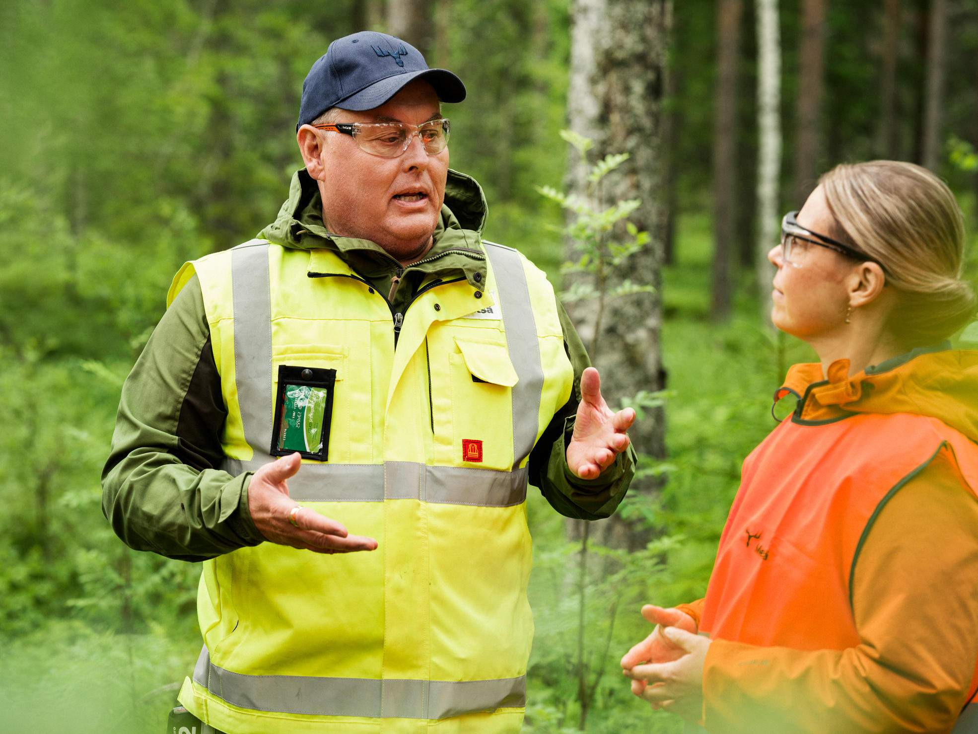 Forest specialist talks to forest owners by a felling site.